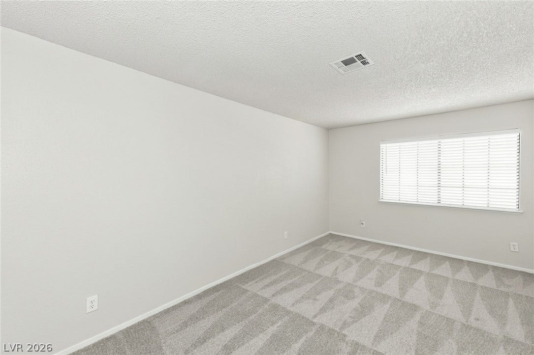 378 Tierra Street, Henderson, NV 89014 A wide window allows natural light to fill this serene bedroom complete with soft carpeting.