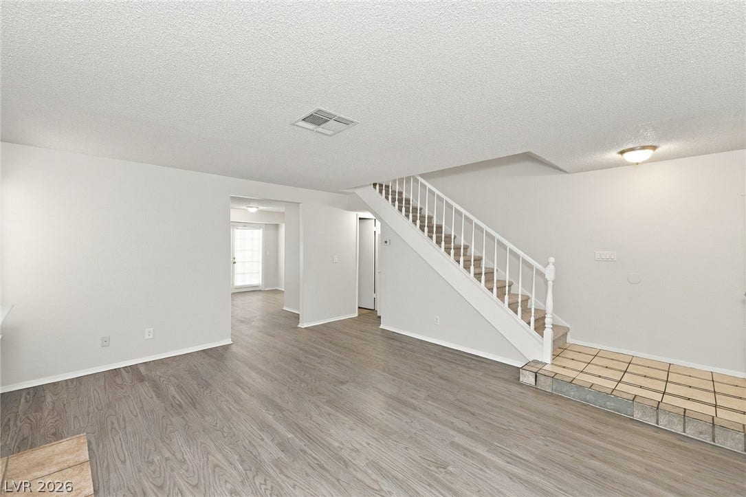 378 Tierra Street, Henderson, NV 89014 Smooth wood-look flooring and an elegant staircase define this versatile living area.