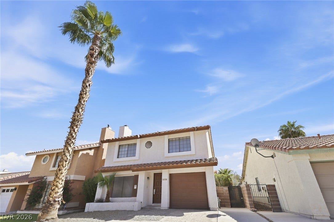 378 Tierra Street, Henderson, NV 89014 An inviting stucco exterior features a tile roof and a tall palm tree out front.