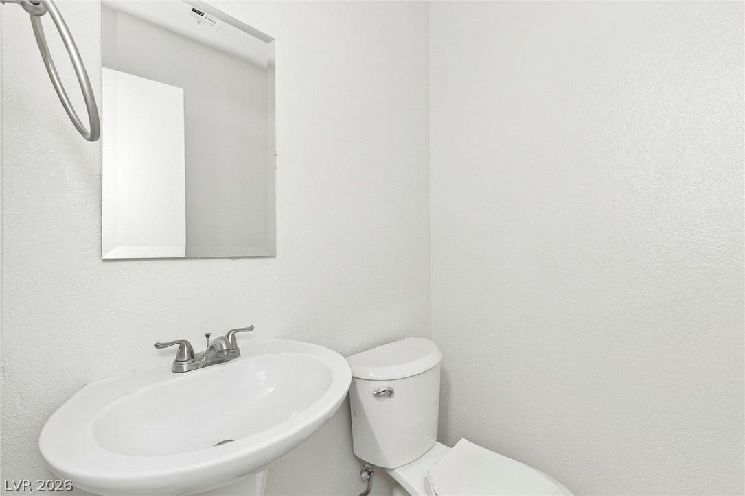 378 Tierra Street, Henderson, NV 89014 A minimalist pedestal sink and matches simple fixtures in this clean powder room.