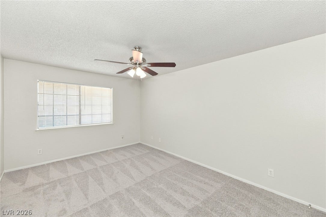 378 Tierra Street, Henderson, NV 89014 Plush carpet flooring and a wide window with integrated blinds define this versatile room.