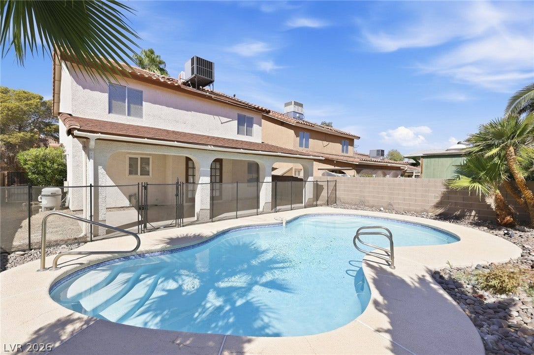 378 Tierra Street, Henderson, NV 89014 An inviting backyard oasis centers around a sparkling swimming pool under clear desert skies.