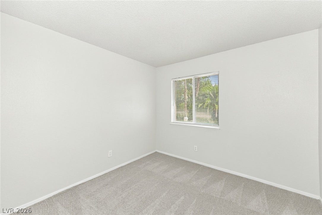 378 Tierra Street, Henderson, NV 89014 Soft carpeting underfoot anchors a simple space illuminated by a central window.