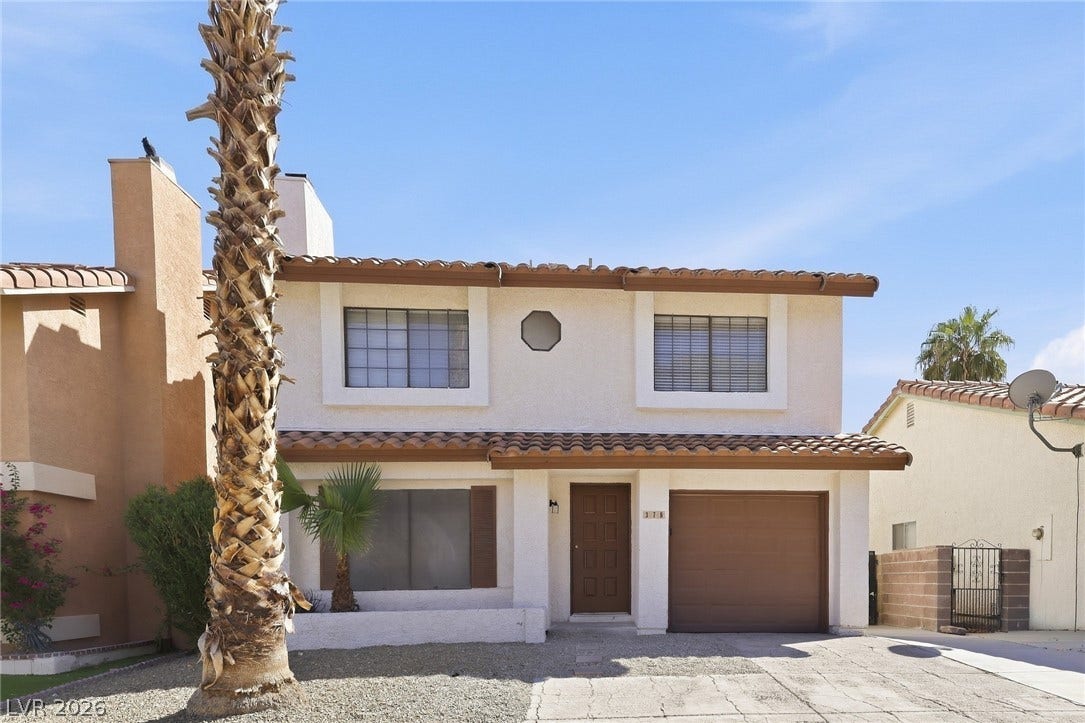 378 Tierra Street, Henderson, NV 89014 A classic two-story facade with Spanish tile roofing and an attached garage.