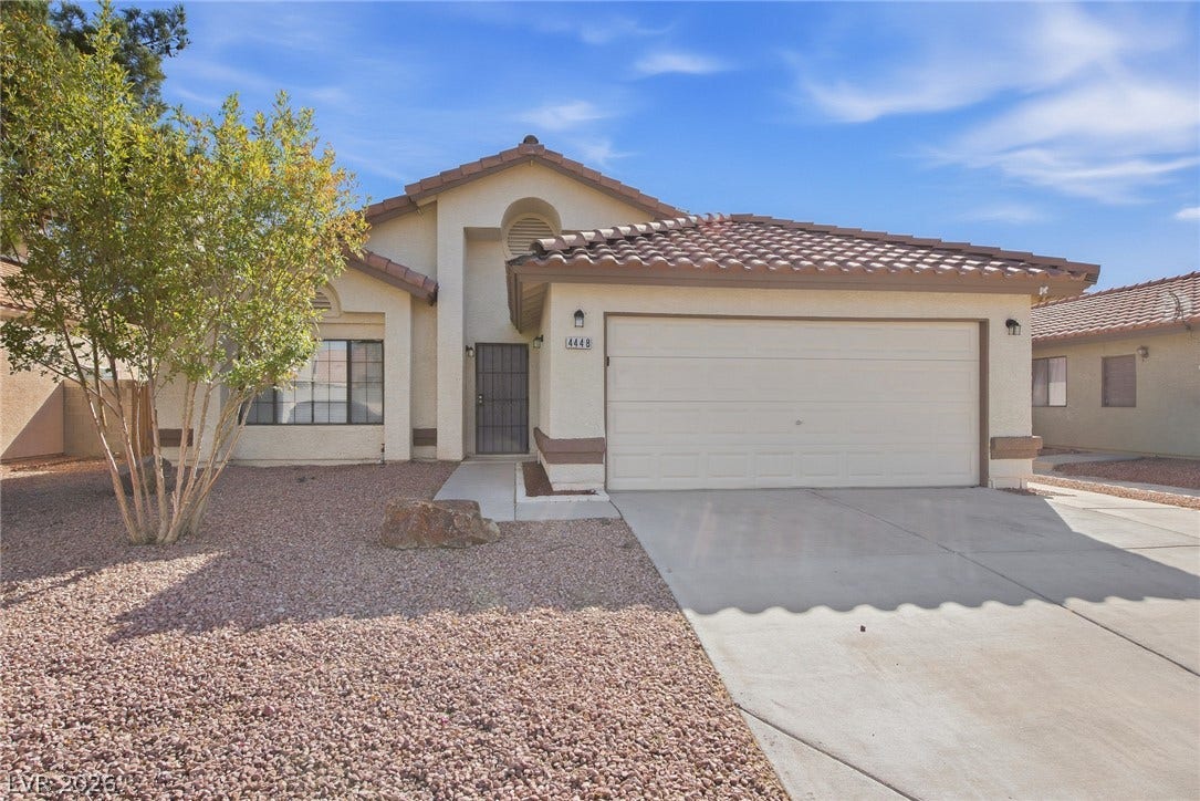 4448 Ryder Lane, North Las Vegas, NV 89031 Classic stucco exterior and tile roofing frame this single-story home with an attached garage.