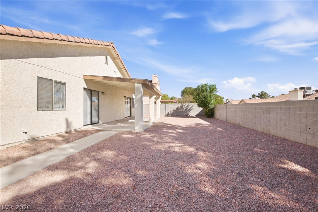 4448 Ryder Lane, North Las Vegas, NV 89031 A spacious gravel backyard features a covered concrete patio and a perimeter privacy wall.