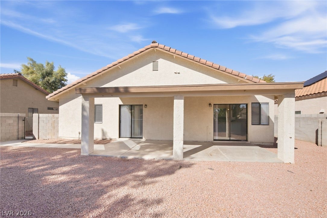 4448 Ryder Lane, North Las Vegas, NV 89031 An inviting covered patio offers a sheltered outdoor space overlooking the low-maintenance gravel yard.