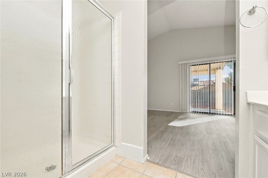 4448 Ryder Lane, North Las Vegas, NV 89031 An en suite bathroom overlooks a spacious bedroom complete with sliding doors to the patio.