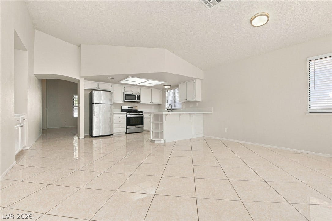 4448 Ryder Lane, North Las Vegas, NV 89031 Polished tile flooring and vaulted ceilings frame this open-concept kitchen and dining area.