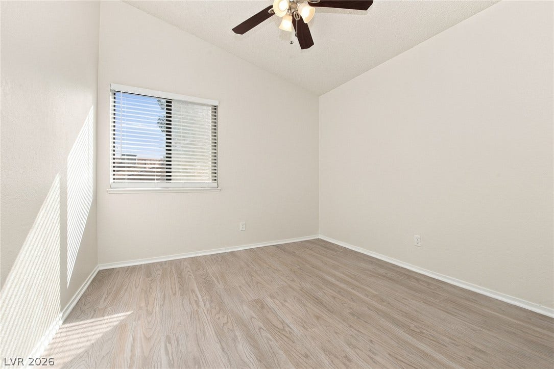 4448 Ryder Lane, North Las Vegas, NV 89031 Vaulted ceilings and wood-style flooring elevate this versatile auxiliary bedroom.