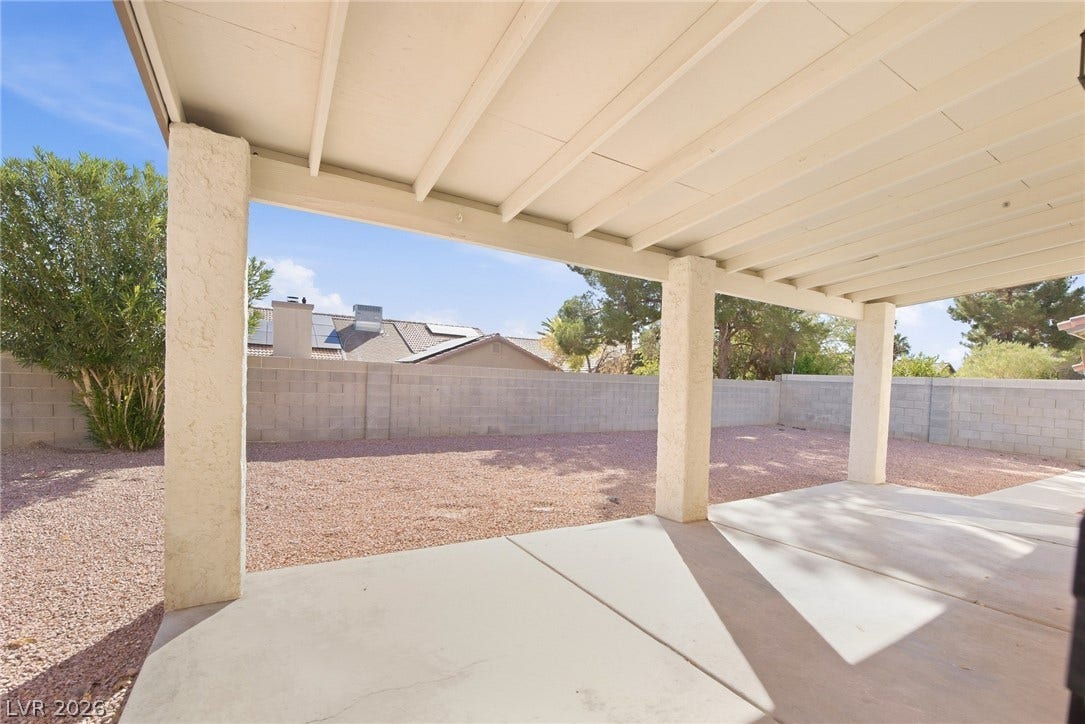 4448 Ryder Lane, North Las Vegas, NV 89031 A spacious covered patio provides a shaded outdoor living space overlooking the fenced yard.