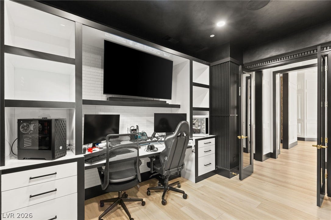 11041 Concord Valley Drive, Las Vegas, NV 89135 Custom built-in cabinetry and warm hardwood flooring define this functional home office workspace.