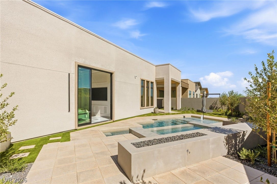 11041 Concord Valley Drive, Las Vegas, NV 89135 A modern patio features clean lines, integrated water features, and expansive sliding glass doors.