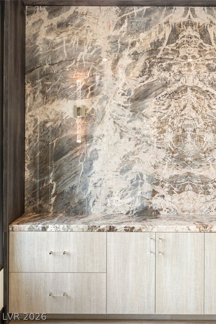 11041 Concord Valley Drive, Las Vegas, NV 89135 Striking bookmatched stone slabs create an elegant backdrop for the built-in storage cabinetry.