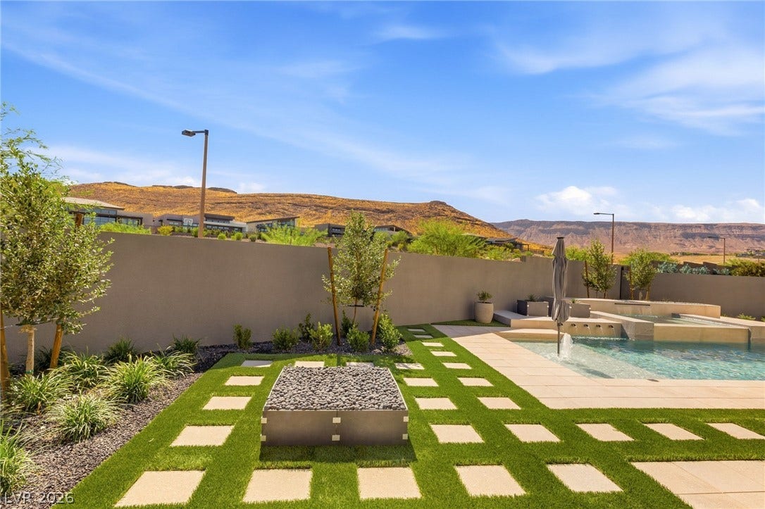11041 Concord Valley Drive, Las Vegas, NV 89135 An inviting backyard oasis offers a pristine pool and a fire pit against mountain views.