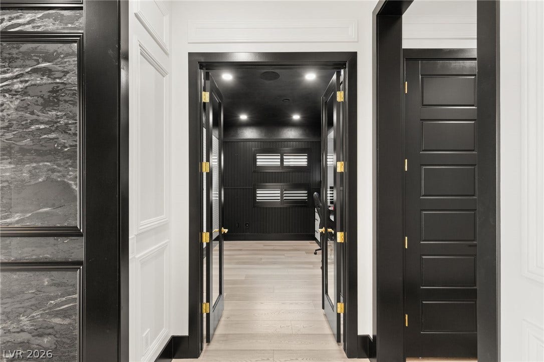 11041 Concord Valley Drive, Las Vegas, NV 89135 Clean lines and custom trim work define this sleek hallway leading to a private office.