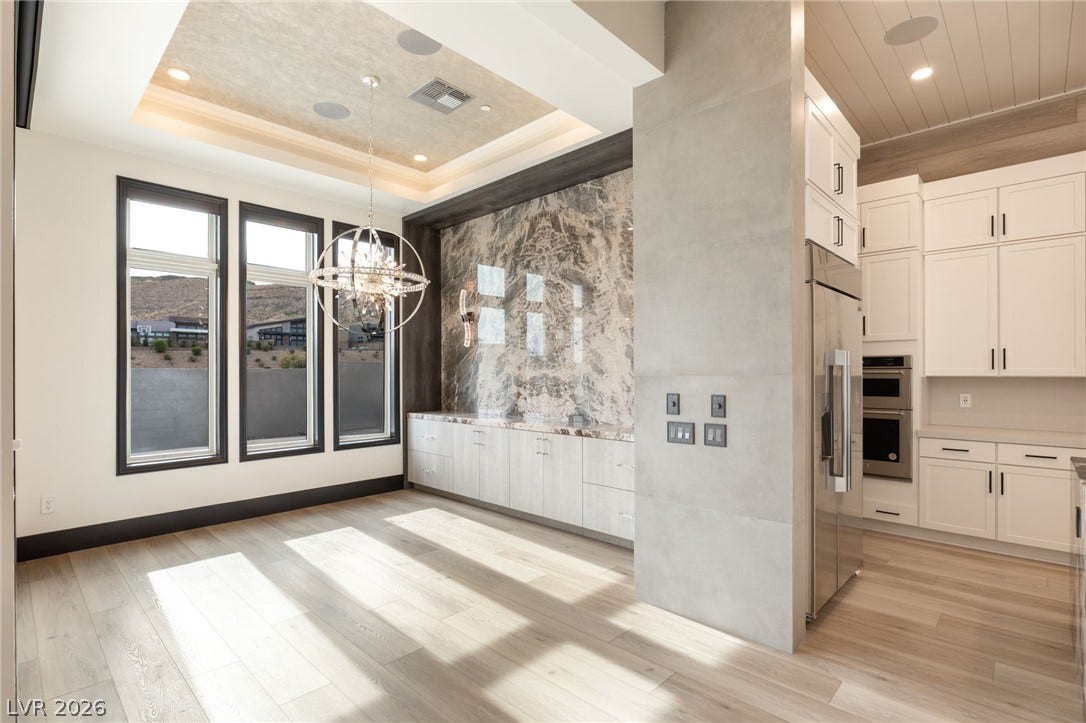 11041 Concord Valley Drive, Las Vegas, NV 89135 Gleaming hardwood floors and a statement stone accent wall define this bright dining space.
