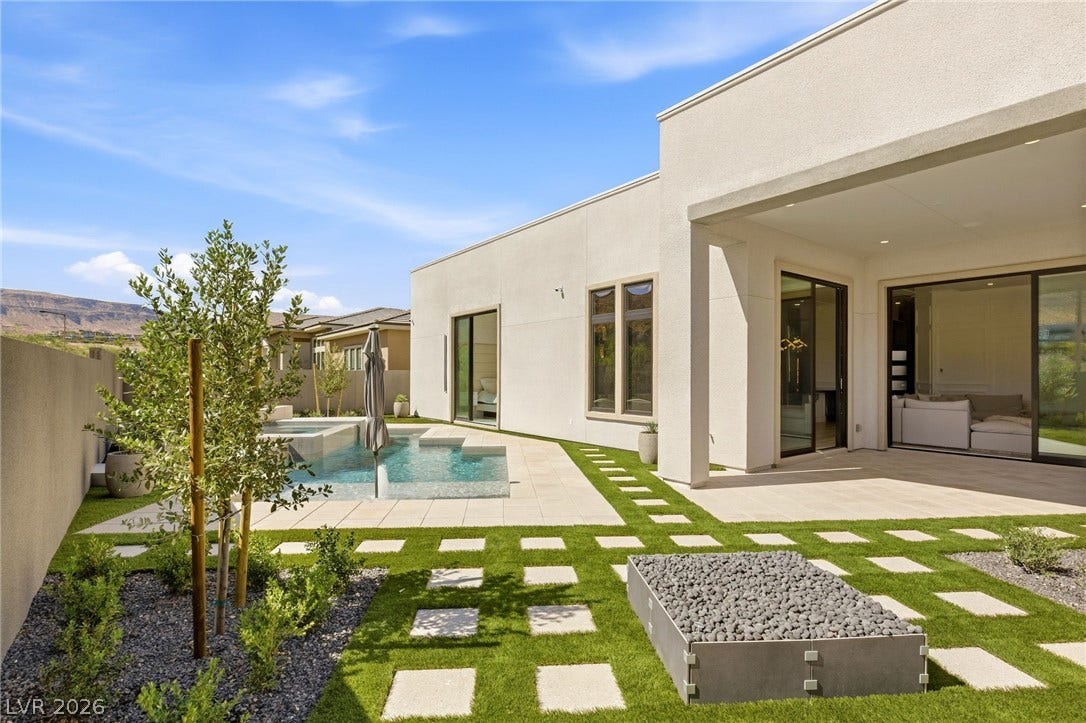 11041 Concord Valley Drive, Las Vegas, NV 89135 A geometric stone path winds through the backyard oasis toward a sparkling swimming pool.