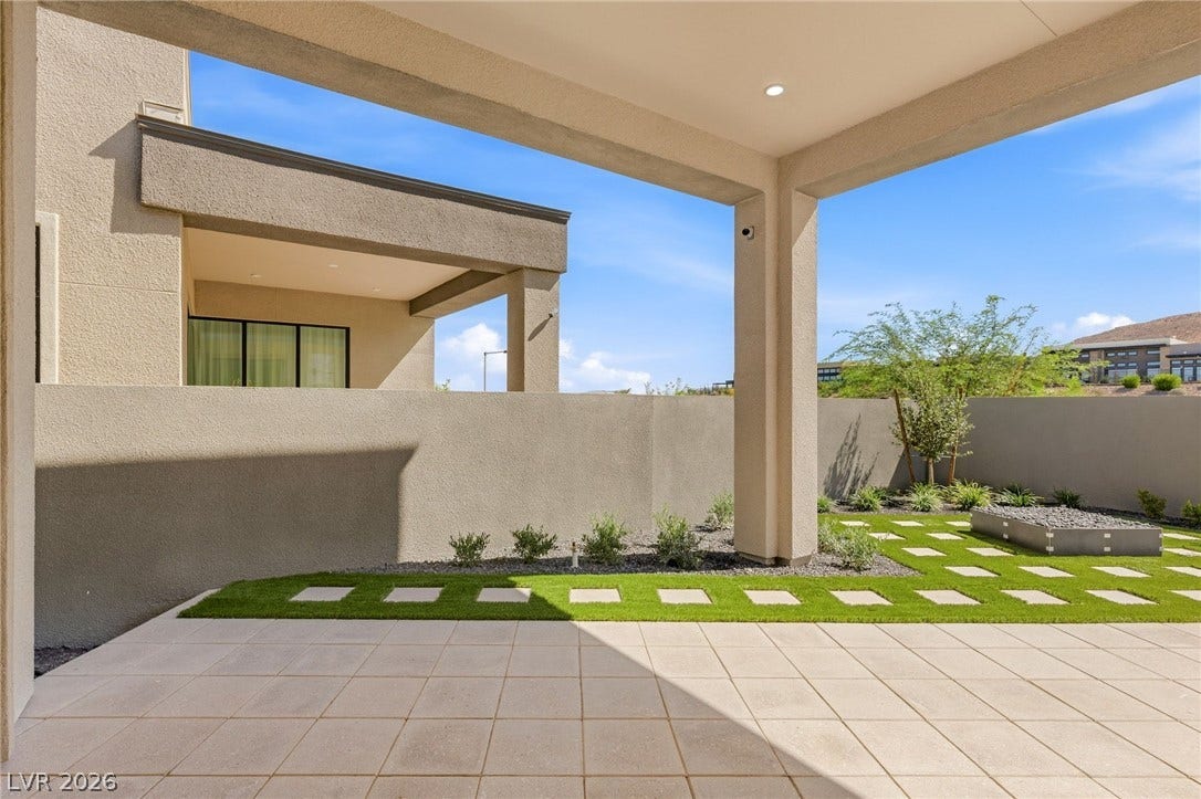 11041 Concord Valley Drive, Las Vegas, NV 89135 Tiled patio flooring extends to a manicured lawn with pavers under a covered shelter.