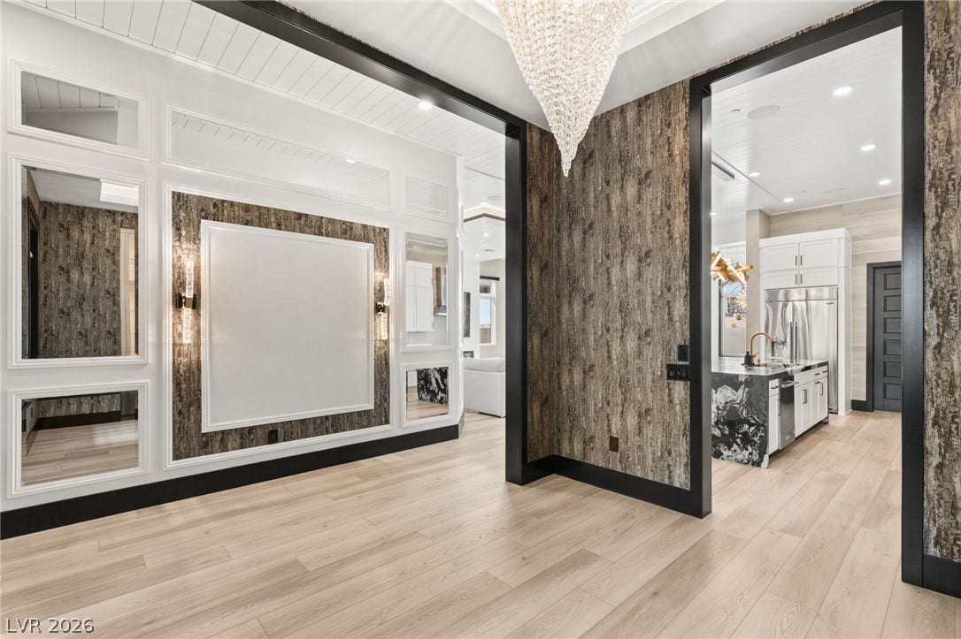 11041 Concord Valley Drive, Las Vegas, NV 89135 Striking architectural wall paneling and sleek wood floors define this grand foyer entryway.