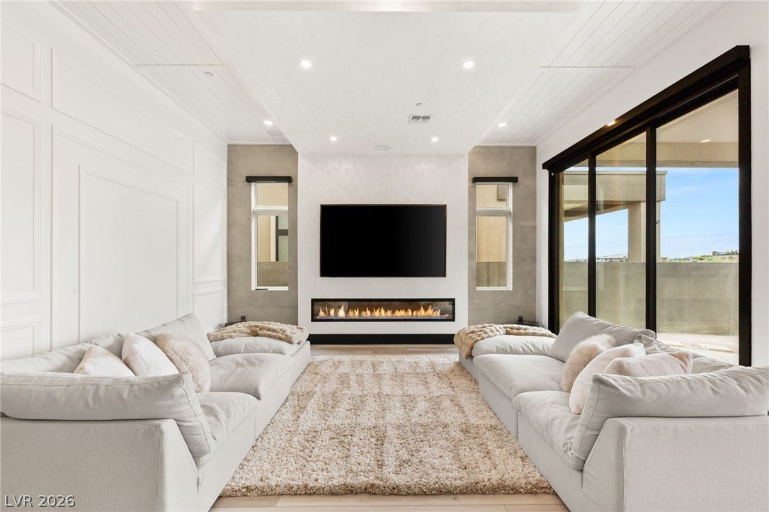11041 Concord Valley Drive, Las Vegas, NV 89135 Large sliding glass doors open to the patio from this modern living space.