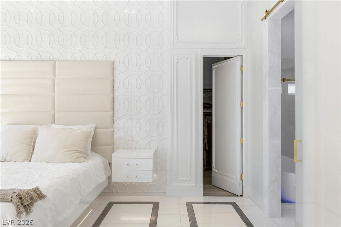 11041 Concord Valley Drive, Las Vegas, NV 89135 Elegant textured wall details and polished tile flooring elevate this serene sleeping space.