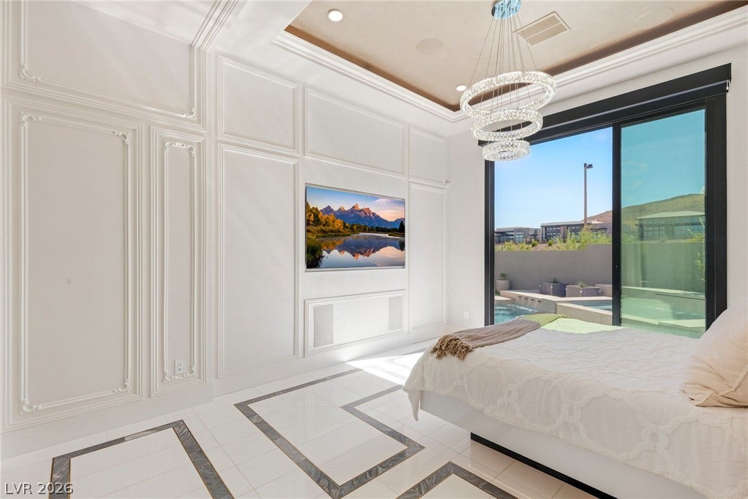 11041 Concord Valley Drive, Las Vegas, NV 89135 Elegant wall molding and inlaid tile flooring frame sliding glass doors to the pool area.