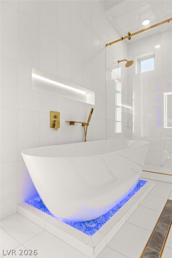 11041 Concord Valley Drive, Las Vegas, NV 89135 Modern minimalist design defines this space with its sleek soaking tub and gold fixtures.