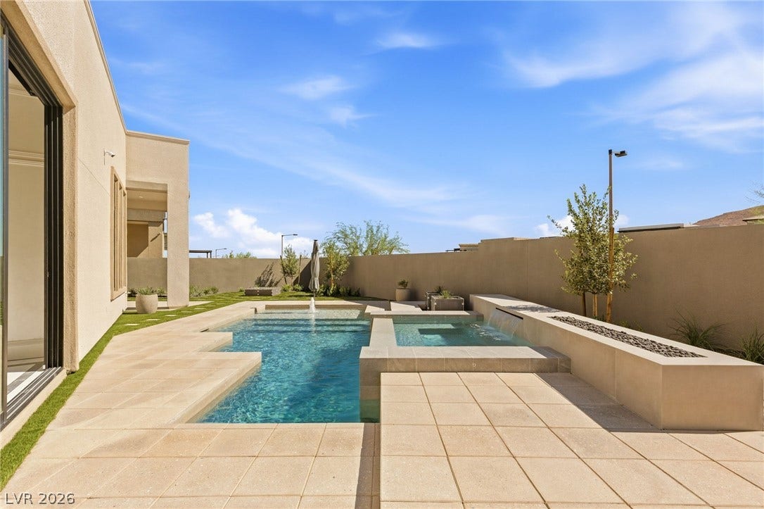 11041 Concord Valley Drive, Las Vegas, NV 89135 An inviting backyard oasis showcases a pristine swimming pool and spa surrounded by stone pavers.