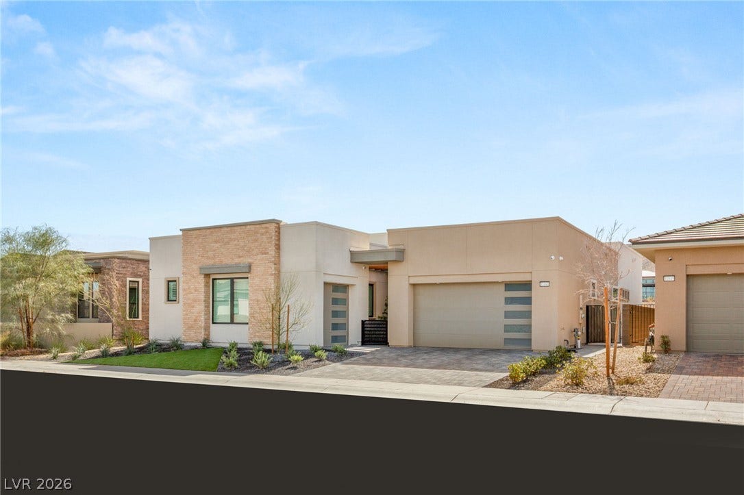 11041 Concord Valley Drive, Las Vegas, NV 89135 Clean lines and stone accents define this modern single-story residence under clear blue skies.