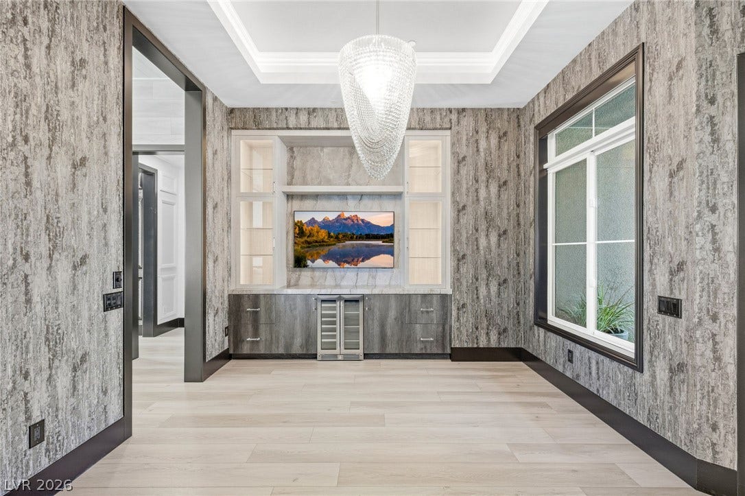 11041 Concord Valley Drive, Las Vegas, NV 89135 An elegant recessed ceiling and custom built-in cabinetry define this modern transitional space.