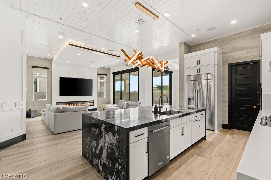 11041 Concord Valley Drive, Las Vegas, NV 89135 Gleaming wood floors and an expansive stone island anchor this modern open floorplan design.