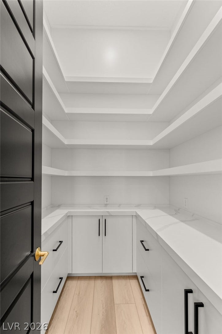 11041 Concord Valley Drive, Las Vegas, NV 89135 Ample built-in shelving and sleek countertops maximize storage in this walk-in pantry.