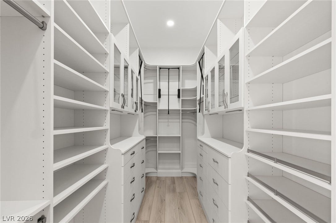 11041 Concord Valley Drive, Las Vegas, NV 89135 Floor-to-ceiling custom shelving and integrated drawers maximize storage space in this master closet.