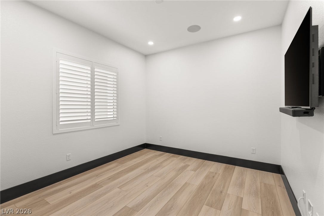 11041 Concord Valley Drive, Las Vegas, NV 89135 Smooth wood floors contrast beautifully with dark baseboards under clean recessed lighting.