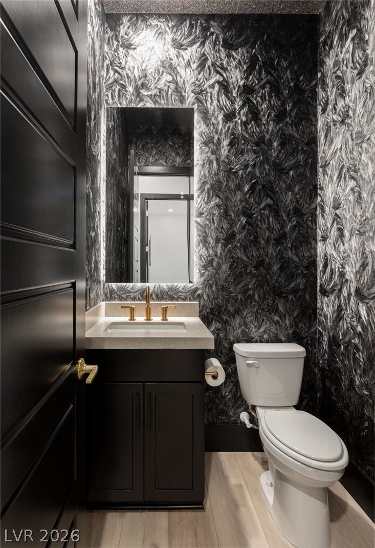 11041 Concord Valley Drive, Las Vegas, NV 89135 Dramatic wall coverings paired with gold hardware create a memorable powder room experience.