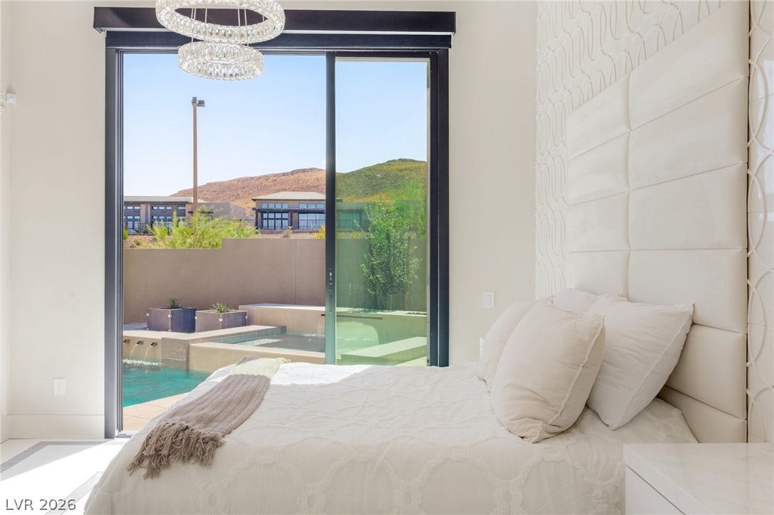 11041 Concord Valley Drive, Las Vegas, NV 89135 Massive sliding glass doors open directly to a private patio and pool area.