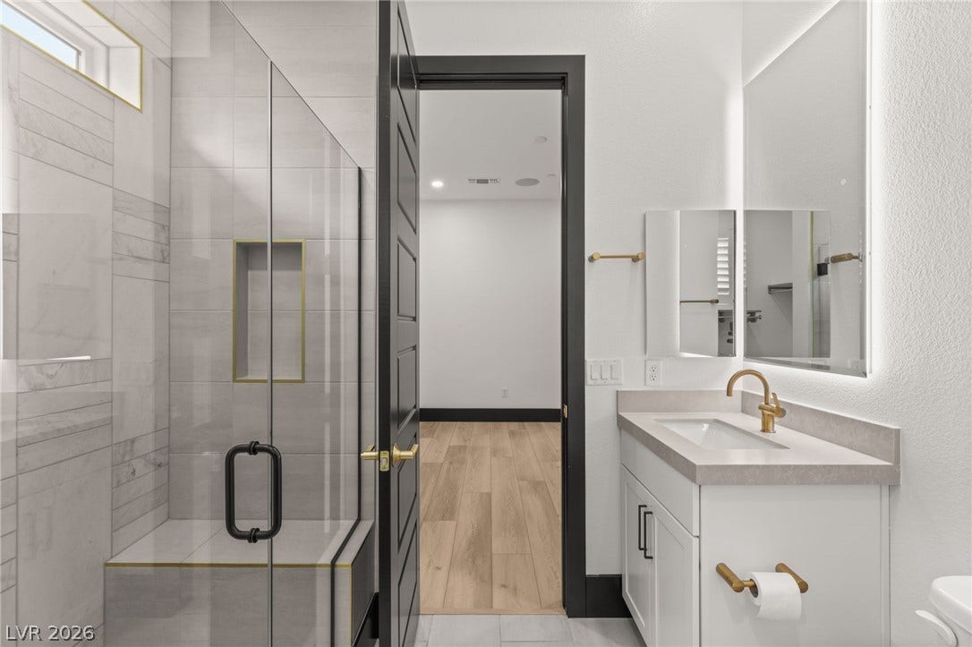 11041 Concord Valley Drive, Las Vegas, NV 89135 Clean lines and a walk-in tile shower define this modern bathroom space.