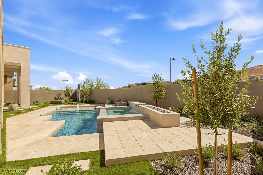 11041 Concord Valley Drive, Las Vegas, NV 89135 An inviting backyard oasis features a clean-lined swimming pool paired with a matching spa.