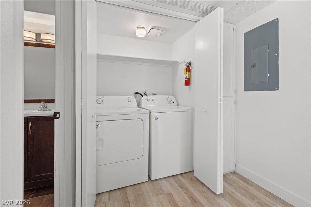 3450 Erva Street, #153, Las Vegas, NV 89117 An organized laundry closet features side-by-side appliances and resilient wood-look flooring.