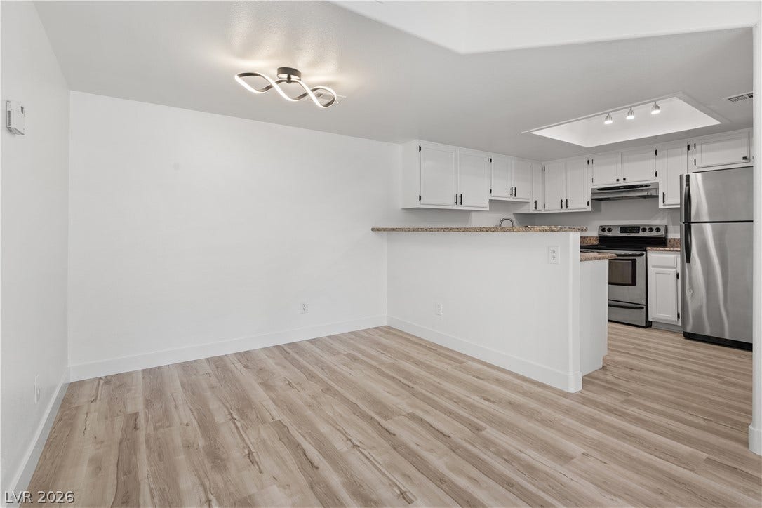3450 Erva Street, #153, Las Vegas, NV 89117 Gleaming wood-look floors anchor this open dining area seamlessly connected to the kitchen.