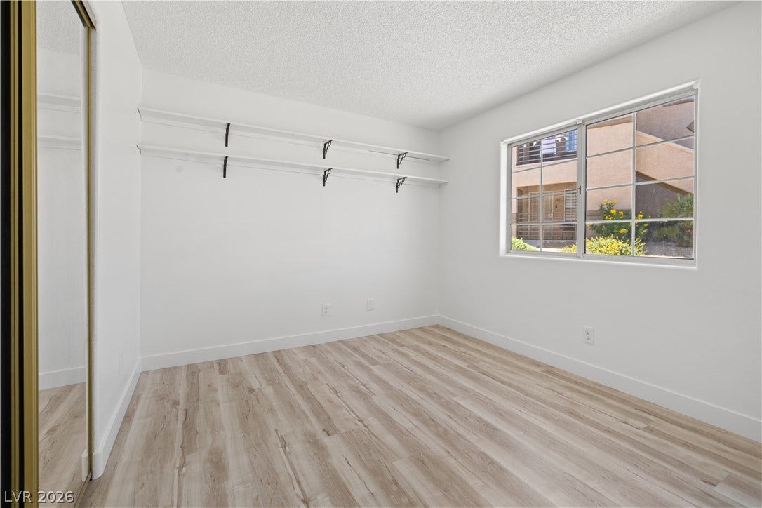 3450 Erva Street, #153, Las Vegas, NV 89117 Smooth wood-look flooring and built-in shelving define this versatile room with natural light.
