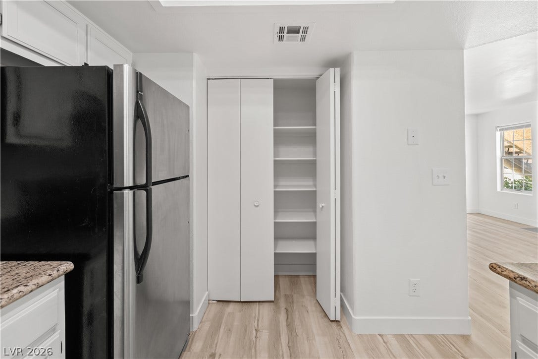 3450 Erva Street, #153, Las Vegas, NV 89117 A spacious built-in pantry with folding doors offers convenient storage near the kitchen area.