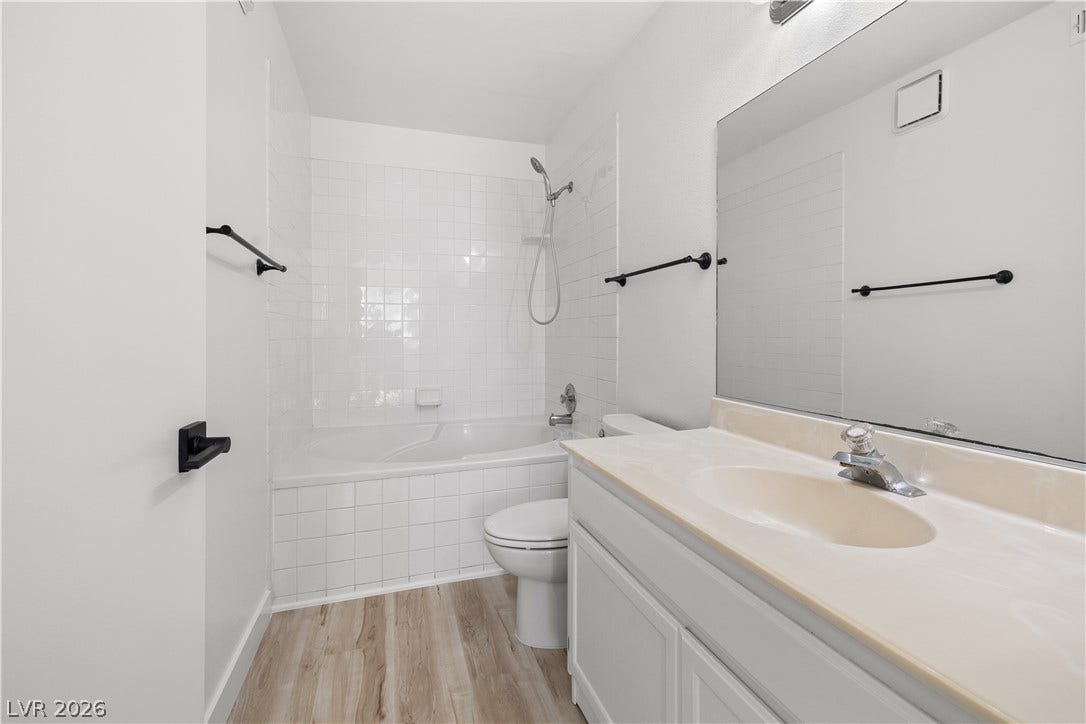 3450 Erva Street, #153, Las Vegas, NV 89117 Clean lines and classic tiling define this well-appointed bathroom with durable plank flooring.