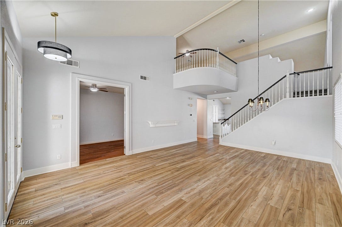 8908 Sheep Ranch Court, Las Vegas, NV 89143 Soaring vaulted ceilings and a dramatic curved balcony overlook the spacious main living areas.