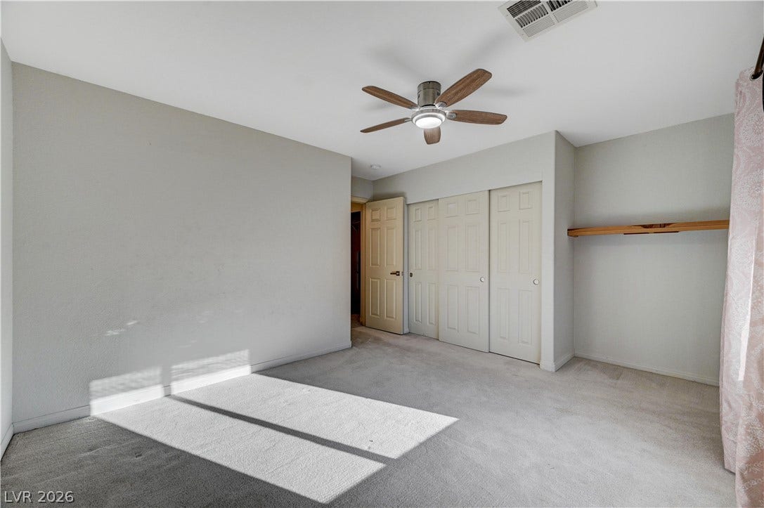 8908 Sheep Ranch Court, Las Vegas, NV 89143 Soft carpeting underfoot and integrated shelving create a comfortable, functional layout.