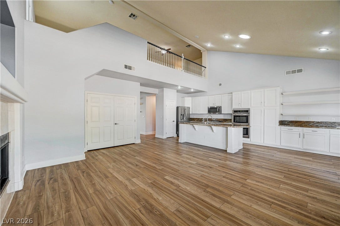 8908 Sheep Ranch Court, Las Vegas, NV 89143 An open floorplan connects the living area and kitchen under soaring vaulted ceilings.
