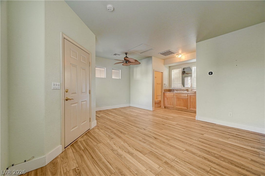 8908 Sheep Ranch Court, Las Vegas, NV 89143 Smooth wood-look flooring anchors this open room featuring an adjacent vanity station.