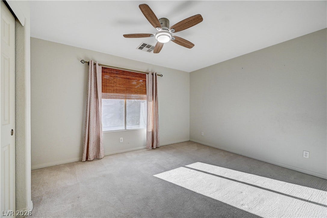 8908 Sheep Ranch Court, Las Vegas, NV 89143 Plentiful natural light streams across the carpeted floor of this versatile bedroom.