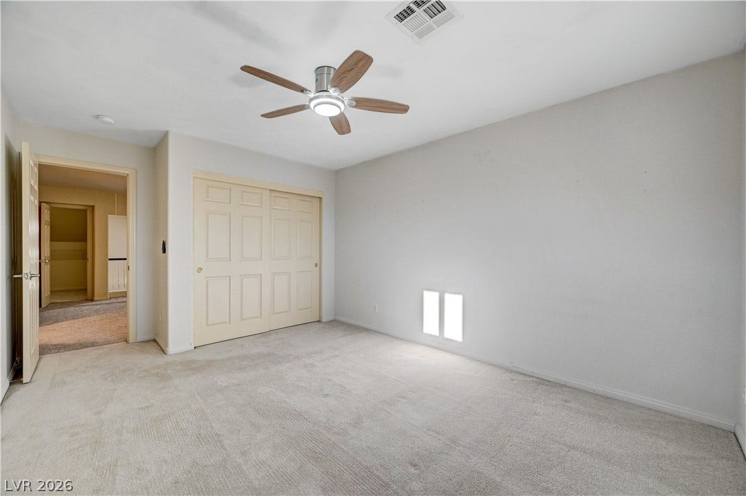 8908 Sheep Ranch Court, Las Vegas, NV 89143 Soft carpeting pairs with neutral walls to create a comfortable and versatile bedroom layout.